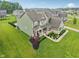 This home features a well manicured lawn, a large front porch and fresh green paint at 8165 Oakley Ter, Zionsville, IN 46077