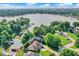 High-angle view of a house close to the water, surrounded by mature trees and neighboring homes at 826 N Lanyard Dr, Cicero, IN 46034