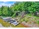 Waterfront property featuring a private dock, boat lift, and landscaped hillside at 826 N Lanyard Dr, Cicero, IN 46034