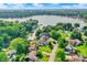 Aerial perspective of a lakefront home with beautiful landscaping and surrounding trees at 826 N Lanyard Dr, Cicero, IN 46034