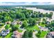 Aerial view of the neighborhood with lush greenery and a lake at 826 N Lanyard Dr, Cicero, IN 46034