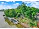 Waterfront property featuring a private dock, boat lift, and beautiful landscaping at 826 N Lanyard Dr, Cicero, IN 46034