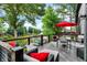 Spacious deck features outdoor seating, a red umbrella, and scenic lake views at 826 N Lanyard Dr, Cicero, IN 46034