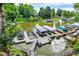 Aerial view of a dock and boat house with multiple boats on the calm lake water at 826 N Lanyard Dr, Cicero, IN 46034