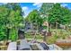 Back exterior view of home with large windows, wooden stairs and terraced backyard at 826 N Lanyard Dr, Cicero, IN 46034