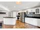 Bright kitchen boasts white cabinets, granite counters, and stainless steel appliances, providing a clean aesthetic at 826 N Lanyard Dr, Cicero, IN 46034