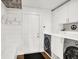 Well-organized laundry room with shiplap walls, and modern appliances at 826 N Lanyard Dr, Cicero, IN 46034