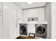 Practical laundry room with a countertop, overhead cabinets, and efficient appliances at 826 N Lanyard Dr, Cicero, IN 46034