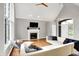 Open concept living area with hardwood floors, featuring a cozy fireplace and natural lighting at 826 N Lanyard Dr, Cicero, IN 46034