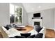 Open concept living area with hardwood floors, featuring a cozy fireplace and a large window at 826 N Lanyard Dr, Cicero, IN 46034