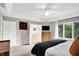 Bright main bedroom features large windows, a ceiling fan, and an ensuite bathroom with tub at 826 N Lanyard Dr, Cicero, IN 46034