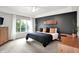 Tranquil main bedroom featuring a tray ceiling, large window, and dark accent wall with modern décor at 826 N Lanyard Dr, Cicero, IN 46034