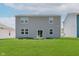 View of a two story home with a flat, green backyard at 848 Holmdale Dr, Indianapolis, IN 46239