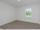 Neutral bedroom features carpeted floors and a window for natural light at 848 Holmdale Dr, Indianapolis, IN 46239