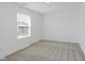 Spare bedroom with a large window for natural light and neutral carpet at 848 Holmdale Dr, Indianapolis, IN 46239