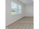 Bright bedroom featuring neutral carpet, crisp white walls, and natural light from a window at 848 Holmdale Dr, Indianapolis, IN 46239