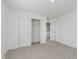 A bright bedroom with light-colored carpet and a sliding door closet at 848 Holmdale Dr, Indianapolis, IN 46239