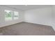 Neutrally decorated bedroom with carpeting and a view from a window at 848 Holmdale Dr, Indianapolis, IN 46239