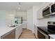 Bright kitchen featuring stainless appliances, quartz countertops, large island and luxury vinyl plank flooring at 848 Holmdale Dr, Indianapolis, IN 46239