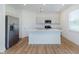 Bright kitchen with stainless steel appliances, quartz countertops, and center island with sink at 848 Holmdale Dr, Indianapolis, IN 46239