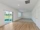 Open living room featuring sliding glass doors, neutral carpet, and light hardwood flooring at 848 Holmdale Dr, Indianapolis, IN 46239
