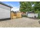 Backyard features a newly-built deck, gravel, and view of the detached garage at 911 Eastern Ave, Indianapolis, IN 46201