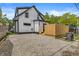 Backyard features a newly-built deck, gravel, and view of the home's exterior at 911 Eastern Ave, Indianapolis, IN 46201