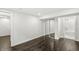 This bedroom features dark hardwood floors and open bathroom concept at 911 Eastern Ave, Indianapolis, IN 46201