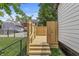View of back deck and yard featuring privacy fence and stairs to yard at 911 Eastern Ave, Indianapolis, IN 46201