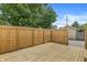 A newly-built wooden deck is surrounded by a tall, wooden fence, perfect for outdoor entertaining at 911 Eastern Ave, Indianapolis, IN 46201