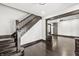 Elegant entryway with hardwood floors, staircase, and views into the open-concept living spaces at 911 Eastern Ave, Indianapolis, IN 46201