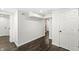 Hallway featuring wood accent wall, dark hardwood floors, and white trim at 911 Eastern Ave, Indianapolis, IN 46201