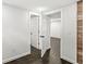 This hallway features dark hardwood floors and white trim at 911 Eastern Ave, Indianapolis, IN 46201