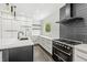 Modern kitchen with stainless steel appliances, custom cabinets, and island at 911 Eastern Ave, Indianapolis, IN 46201