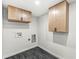 This laundry room features overhead cabinets and modern finishes at 911 Eastern Ave, Indianapolis, IN 46201
