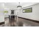 Open-concept living room with dark wood floors, chandelier, and views into the kitchen at 911 Eastern Ave, Indianapolis, IN 46201