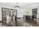 Open-concept living room with dark wood floors and view of kitchen with island at 911 Eastern Ave, Indianapolis, IN 46201