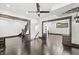 Spacious living room with dark wood floors, ceiling fan, and decorative wall trim at 911 Eastern Ave, Indianapolis, IN 46201