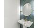 Stylish powder room with geometric tile, pedestal sink, and modern lighting at 911 Eastern Ave, Indianapolis, IN 46201