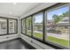 Bright sunroom featuring many windows offering natural light and neighborhood views at 911 Eastern Ave, Indianapolis, IN 46201