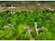 Aerial view of homes with a pool surrounded by mature trees in a lush, green landscape at 9378 N County Road 75 W, Lizton, IN 46149