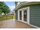 A covered wooden deck, with double doors, adds an outdoor living space at 9378 N County Road 75 W, Lizton, IN 46149