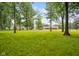 Extensive green backyard featuring a home and mature trees under a clear blue sky at 9378 N County Road 75 W, Lizton, IN 46149