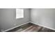 This bedroom features modern plank flooring, neutral walls, and a sunlit window for a serene living space at 9378 N County Road 75 W, Lizton, IN 46149