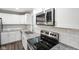 Close up view of kitchen with granite countertops, white cabinets, stainless appliances, and subway tile backsplash at 9378 N County Road 75 W, Lizton, IN 46149