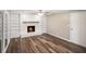 Spacious living room featuring a white brick fireplace, built-in bookshelves, and hardwood floors at 9378 N County Road 75 W, Lizton, IN 46149