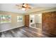 Light-filled sunroom with vaulted ceiling, brick accent wall, and outdoor views at 9378 N County Road 75 W, Lizton, IN 46149