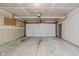 Spacious garage with white walls, concrete floor, white garage door, and lighting at 9406 Avon Strand # Apt A, Avon, IN 46123