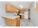Functional kitchen with light wood cabinets, modern appliances, and tile flooring at 9406 Avon Strand # Apt A, Avon, IN 46123