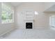 Bright living room with fireplace, built-in shelving, and large windows at 9406 Avon Strand # Apt A, Avon, IN 46123